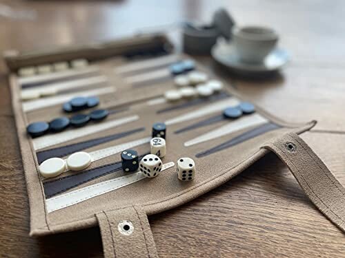 Backgammon game set with dice and checkers on a table.