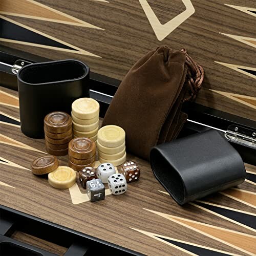 Backgammon set with dice, cups, and checkers on a board.