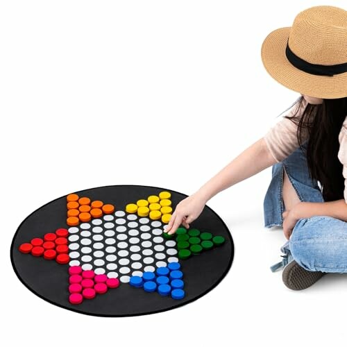 Person playing Chinese checkers on a star-shaped board.