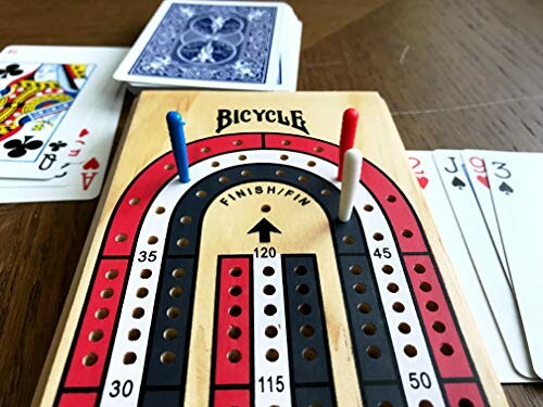 Cribbage board with pegs and playing cards