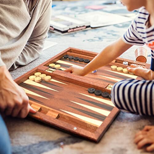 Family playing backgammon on a wooden board