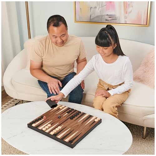 Father and daughter playing backgammon at home.