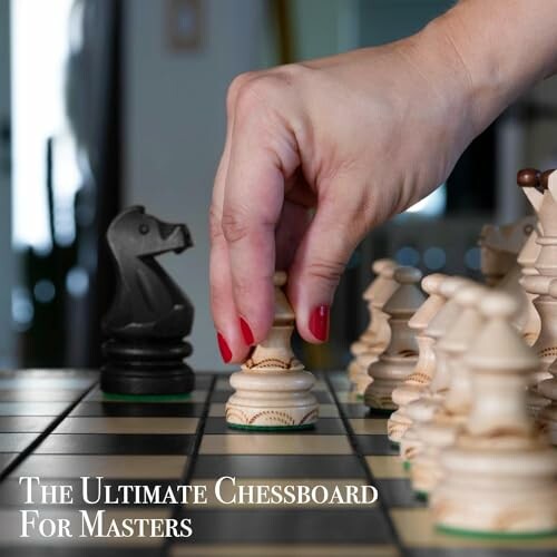 Hand moving chess piece on board with black knight visible