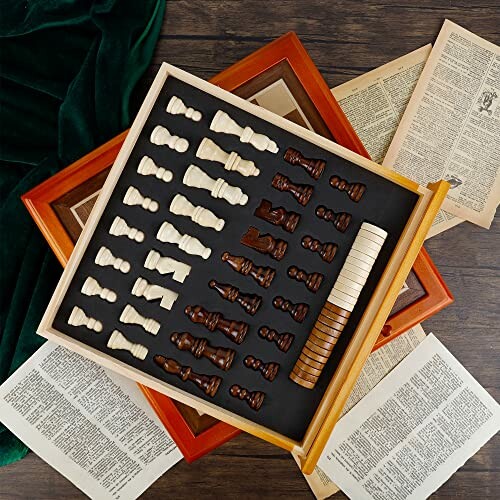 Vintage chess set with wooden chess pieces and score counters on a wooden board surrounded by old book pages.