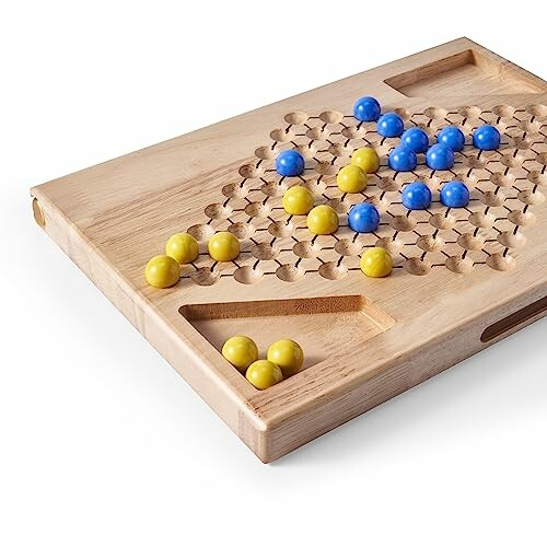 Wooden board game with blue and yellow marbles.