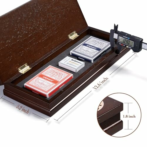 Wooden box holding playing cards with measurement tool