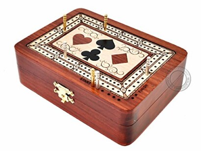 Wooden cribbage board box with card suit design and pegs.