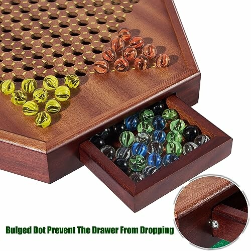 Wooden board game with colorful marbles and storage drawer.